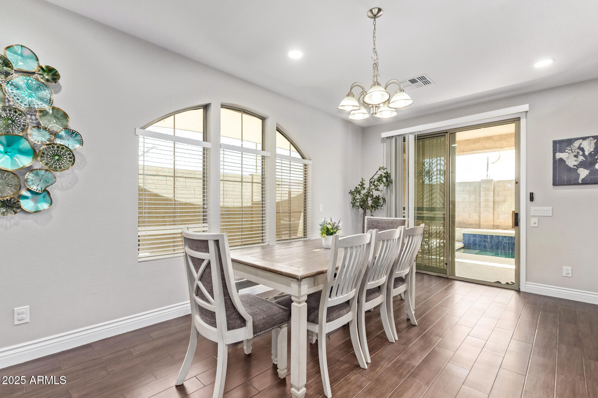 2225 West Carter Road Phoenix, AZ 85041 - Photo 10 of 33 a view of a dining room with furniture a chandelier and wooden floor