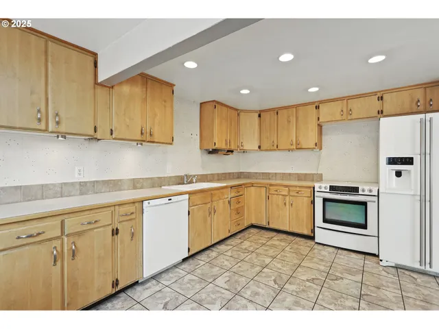 a kitchen with sink cabinets and window