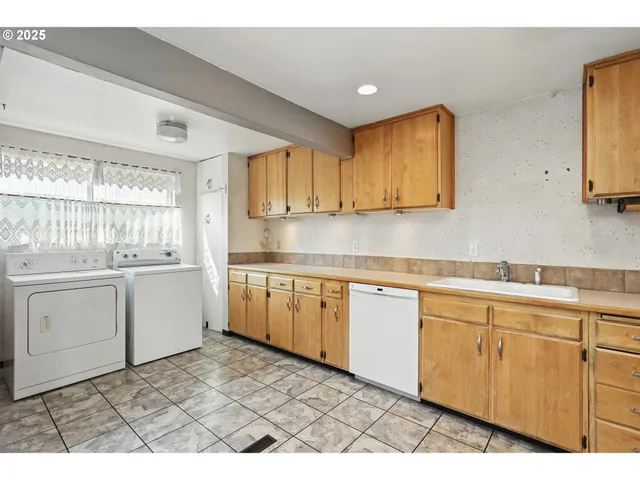 a kitchen with refrigerator cabinets and stove