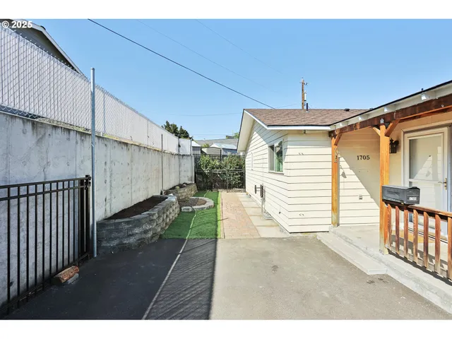 a view of a dirt road and a building