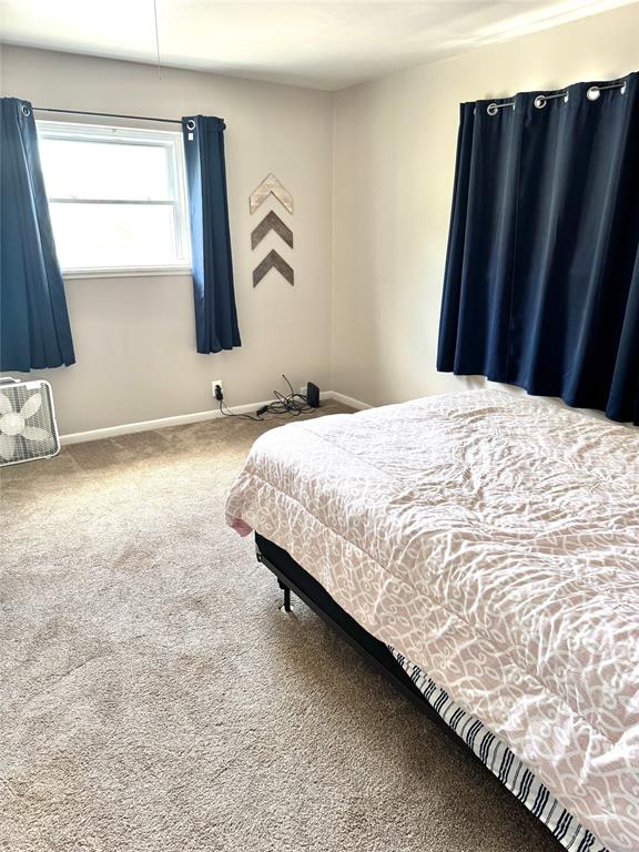 705 Loop Road Quanah, TX 79252 - Photo 10 of 14 a bedroom with a bed and a window