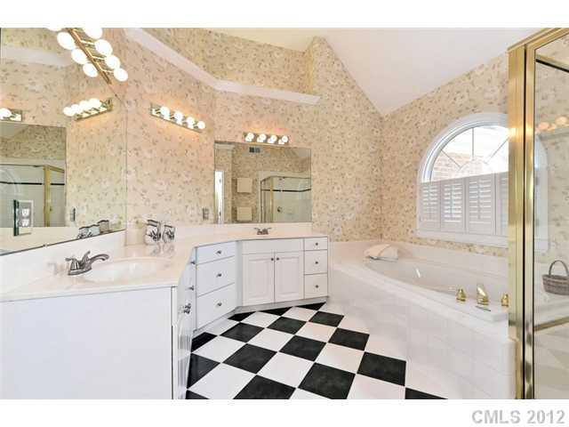 109 Fairwind Court Fort Mill, SC 29708 - Photo 14 of 16 a bathroom with a sink a large mirror and shower