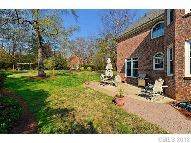 109 Fairwind Court Fort Mill, SC 29708 - Photo 3 of 16 a view of a backyard with table and chairs with wooden fence