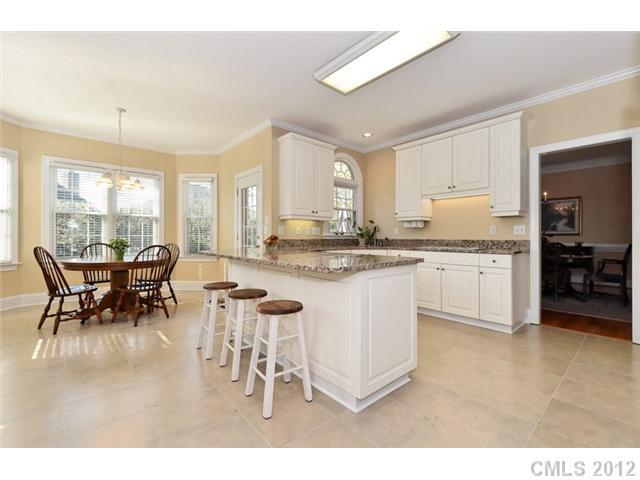 109 Fairwind Court Fort Mill, SC 29708 - Photo 9 of 16 a kitchen with a dining table chairs and white cabinets