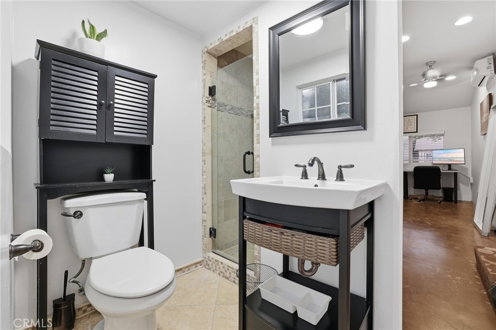 1954 Addison Way Los Angeles, CA 90041 - Photo 12 of 40 a bathroom with a toilet a sink and mirror