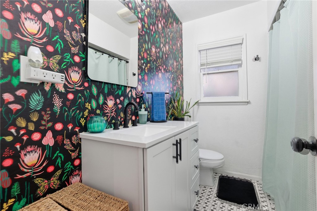1954 Addison Way Los Angeles, CA 90041 - Photo 18 of 40 a bathroom with a sink a toilet and a shower curtain