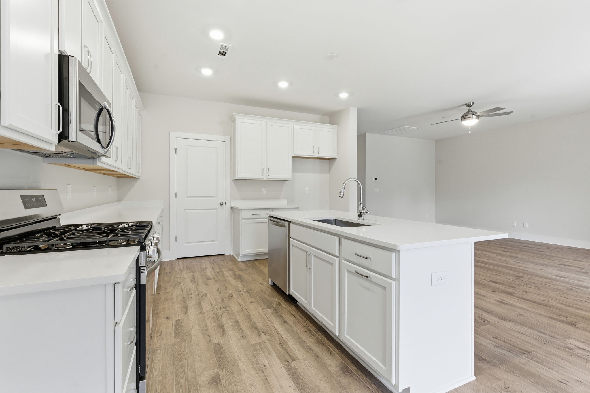 1429 Charles Drive Chapel Hill, TN 37034 - Photo 23 of 24 a kitchen with granite countertop a sink a stove top oven and white cabinets