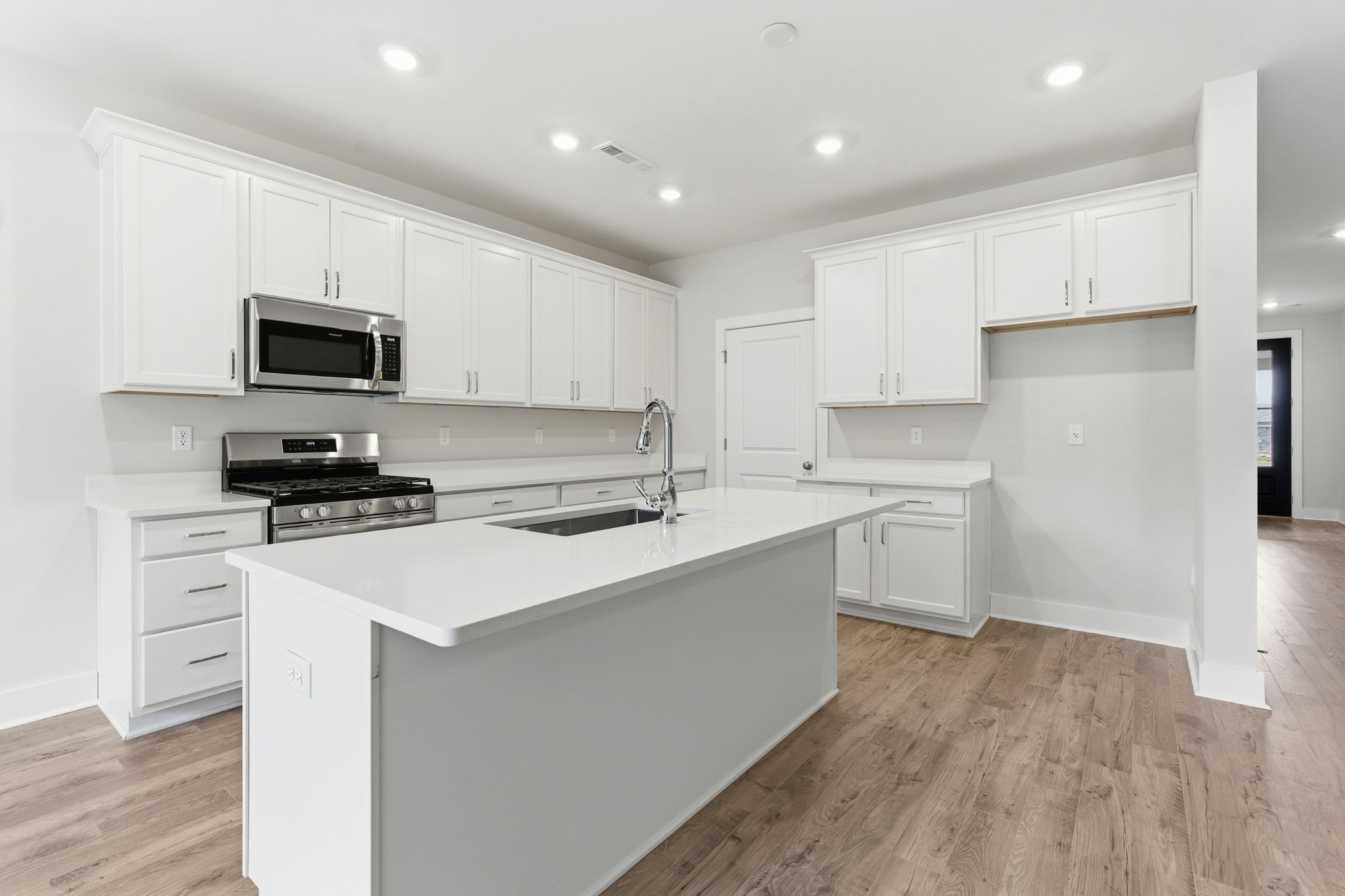1429 Charles Drive Chapel Hill, TN 37034 - Photo 3 of 24 a kitchen with a sink a stove top oven and white cabinets