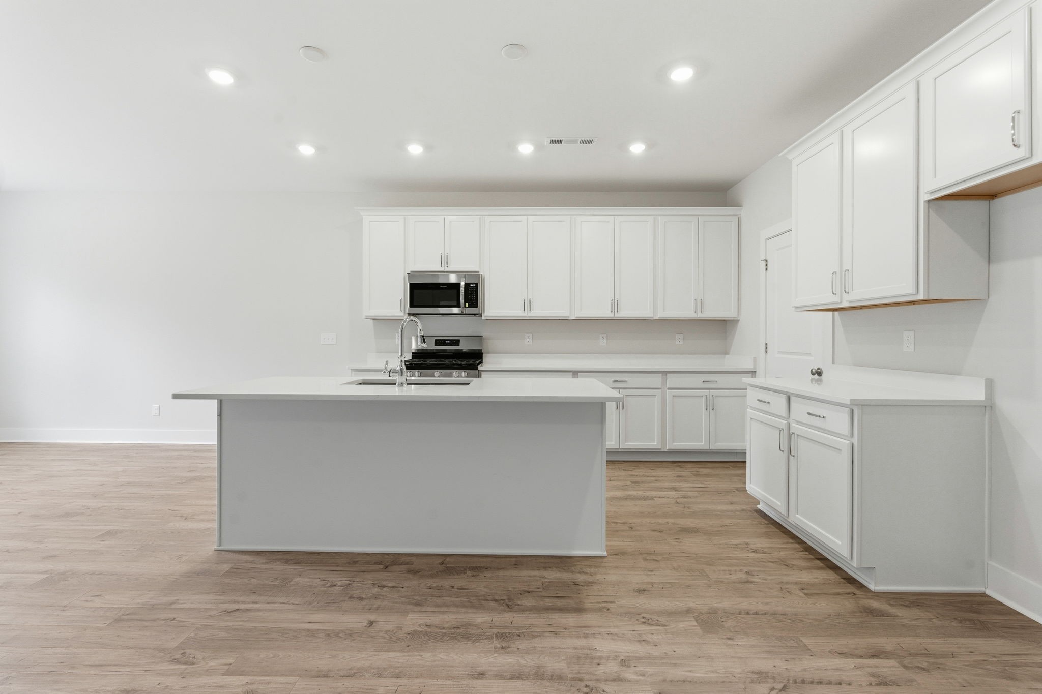 1429 Charles Drive Chapel Hill, TN 37034 - Photo 6 of 24 a kitchen with white cabinets and stainless steel appliances