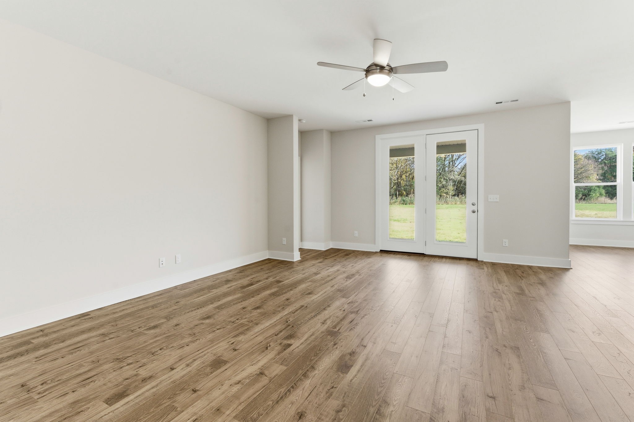 1429 Charles Drive Chapel Hill, TN 37034 - Photo 8 of 24 an empty room with wooden floor chandelier fan and windows