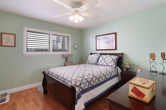 a bed sitting in a bedroom next to a window