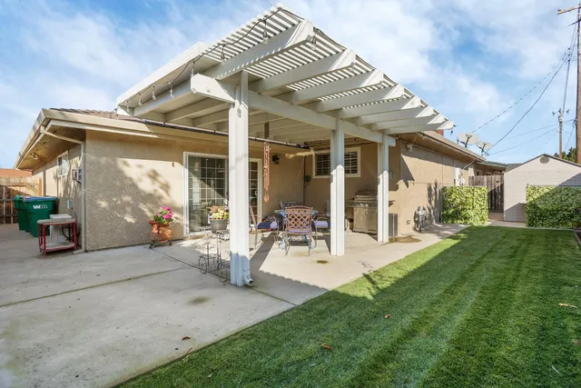 a view of a house with yard and sitting area