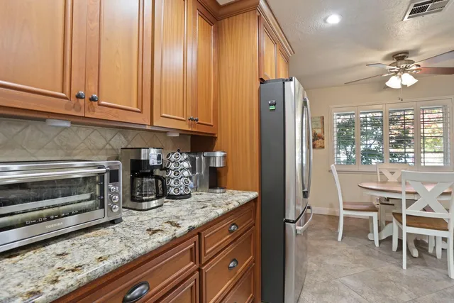 a kitchen with granite countertop sink cabinets and stainless steel appliances