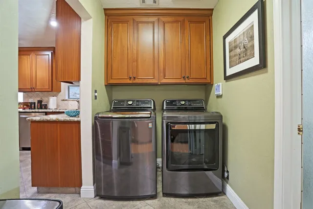 a kitchen with stainless steel appliances granite countertop a refrigerator and a stove