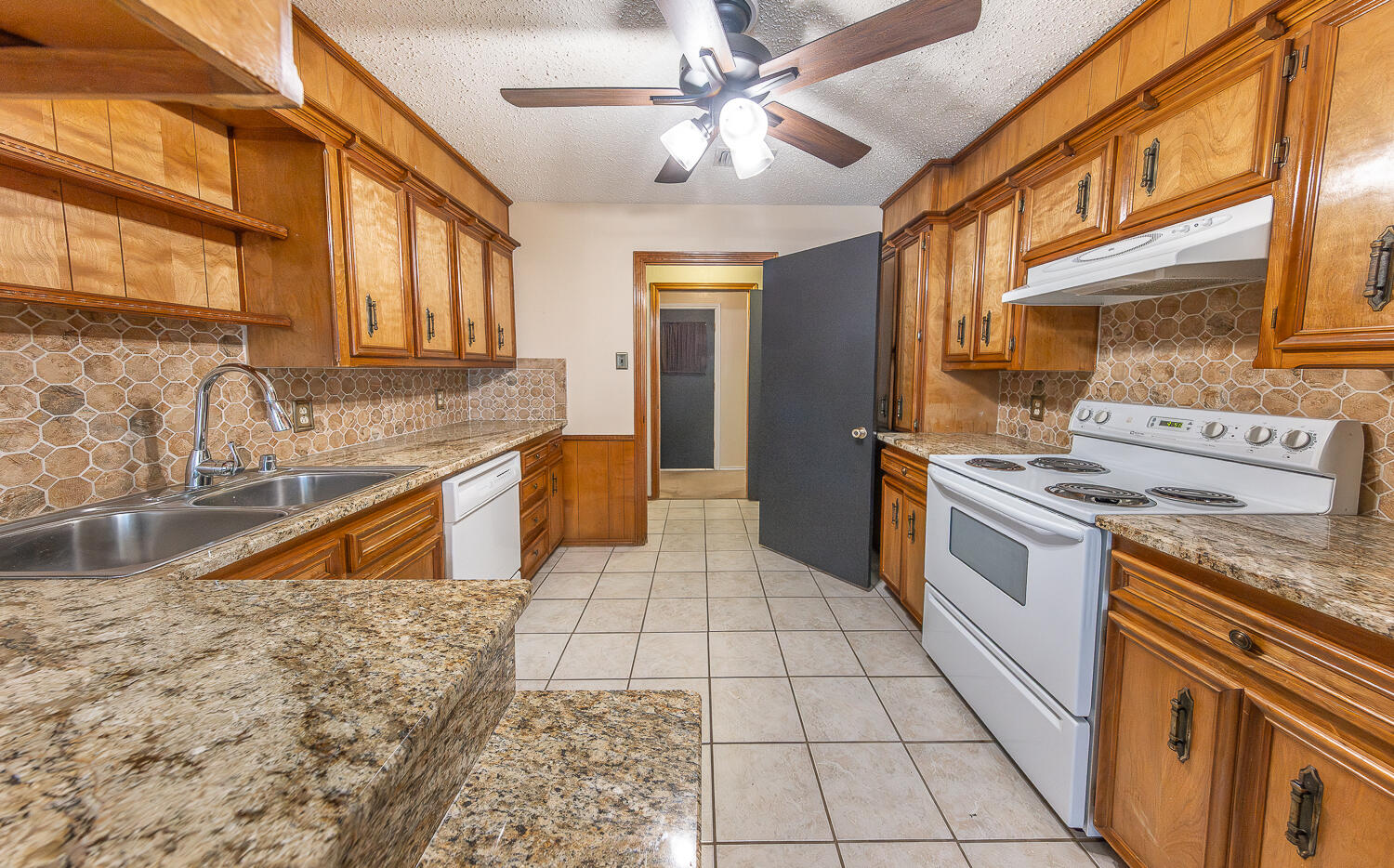4828 73rd Street Lubbock, TX 79424 - Photo 3 of 23 a kitchen with stainless steel appliances granite countertop a sink and a stove