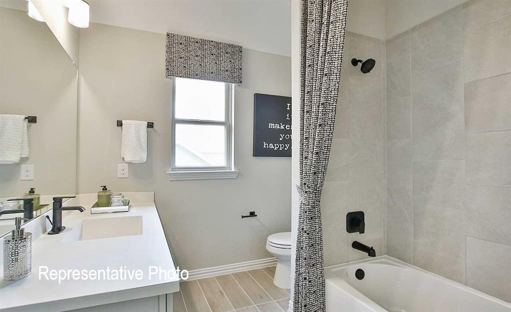 2845 Taylor Trail Corinth, TX 76210 - Photo 10 of 14 Bathroom featuring a single vanity with integrated rectangular sink, matte black faucet, and a large mirror