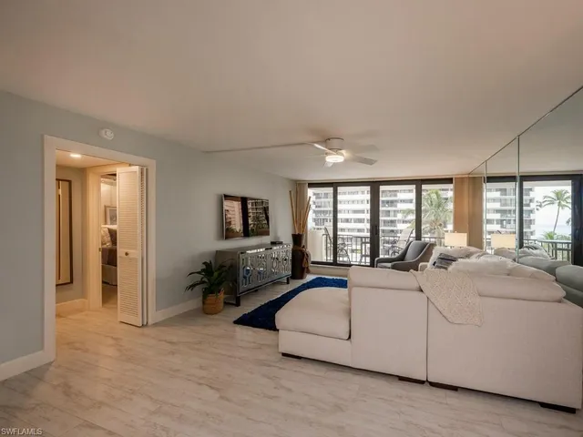 a large bedroom with a bed and wooden floor