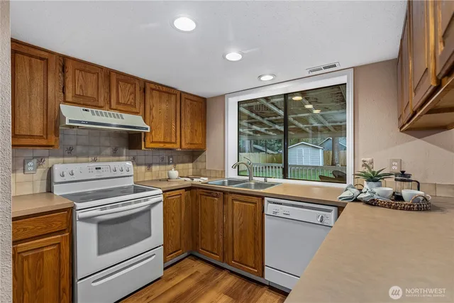 a kitchen with a sink stove and microwave