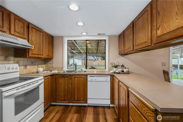 a kitchen with a sink stove and cabinets