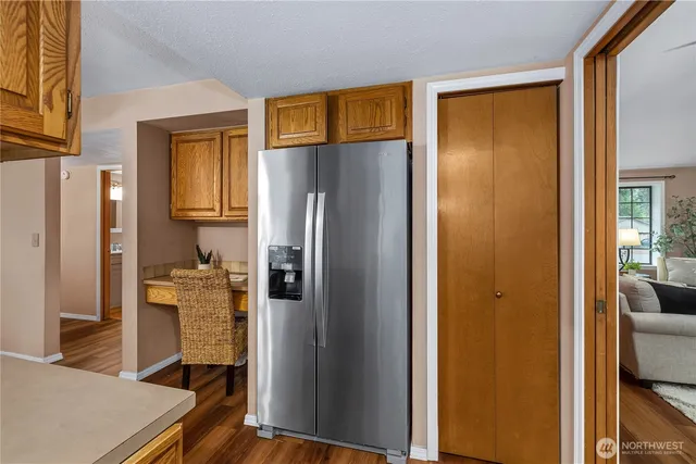 a kitchen with stainless steel appliances granite countertop a refrigerator and a stove