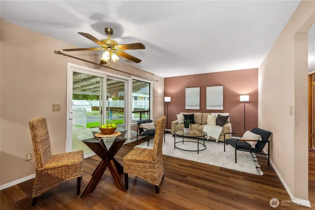a living room with furniture and floor to ceiling windows