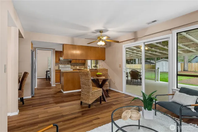 a view of a livingroom with furniture wooden floor and a floor to ceiling window