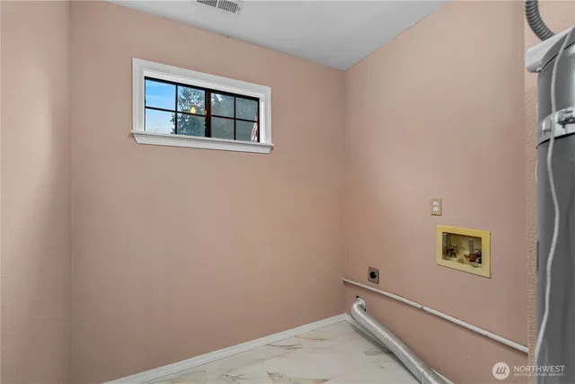 a view of storage and utility room with a window