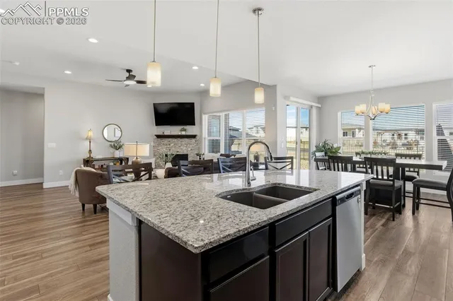 a kitchen with stainless steel appliances granite countertop a sink a stove and a refrigerator