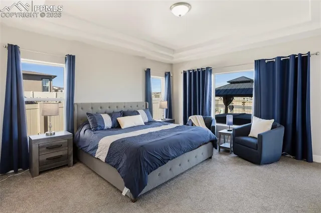 a spacious bedroom with a bed and flat screen tv