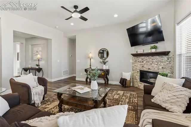 a living room with fireplace furniture and a flat screen tv