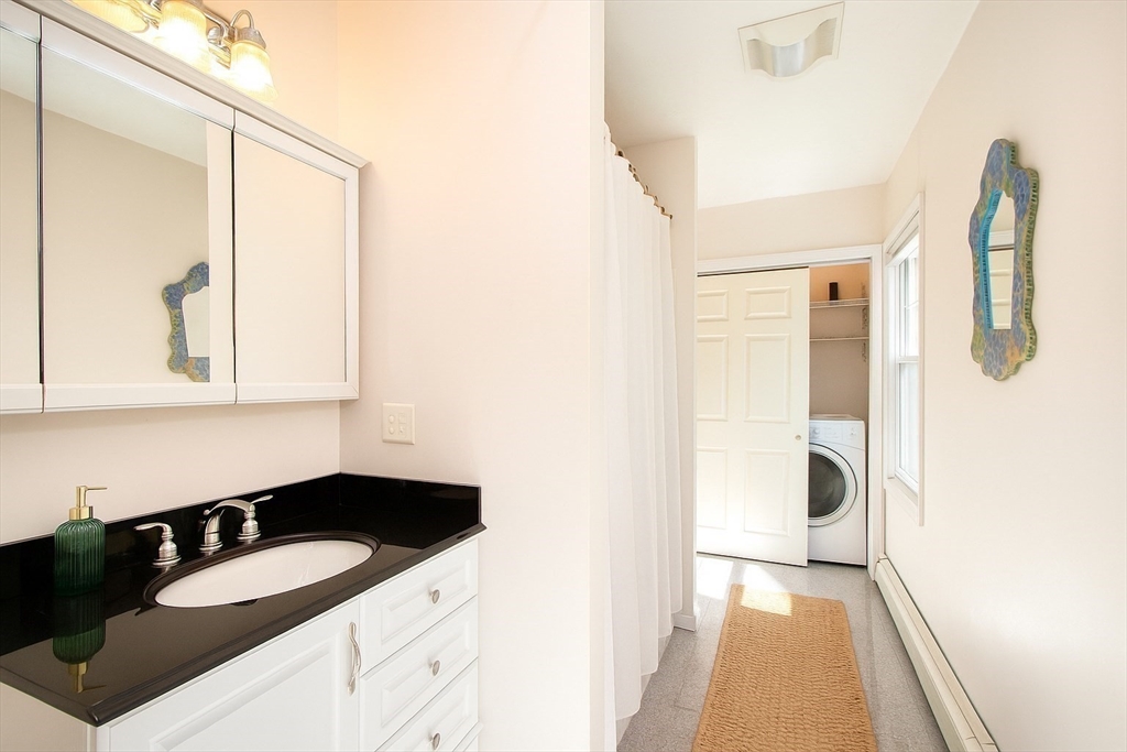 480 Ferry Street Marshfield, MA 02050 - Photo 13 of 34 a bathroom with a granite countertop sink and a mirror
