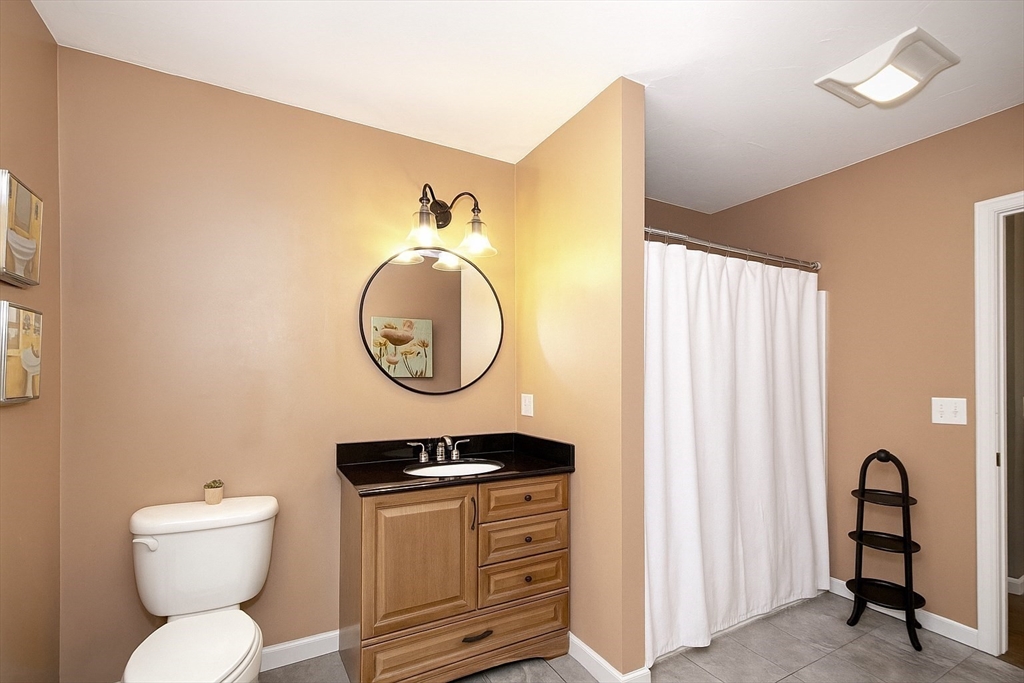 480 Ferry Street Marshfield, MA 02050 - Photo 16 of 34 a bathroom with a toilet a sink and a mirror