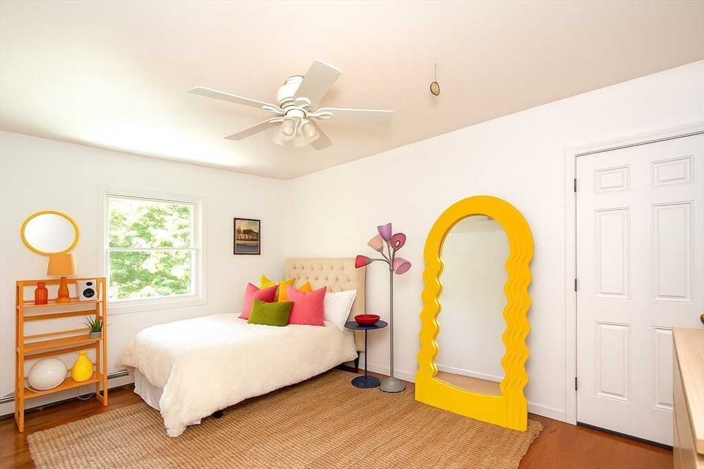 480 Ferry Street Marshfield, MA 02050 - Photo 17 of 34 a bedroom with a bed and a chandelier