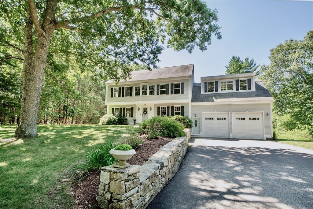 480 Ferry Street Marshfield, MA 02050 - Photo 26 of 34 a front view of a house with a garden and trees