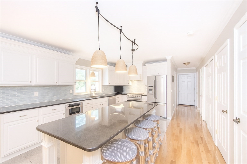 480 Ferry Street Marshfield, MA 02050 - Photo 5 of 34 a kitchen with stainless steel appliances granite countertop a sink a stove and a wooden floors