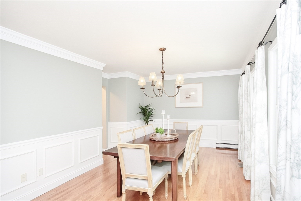 480 Ferry Street Marshfield, MA 02050 - Photo 8 of 34 a dining room with furniture a chandelier and wooden floor
