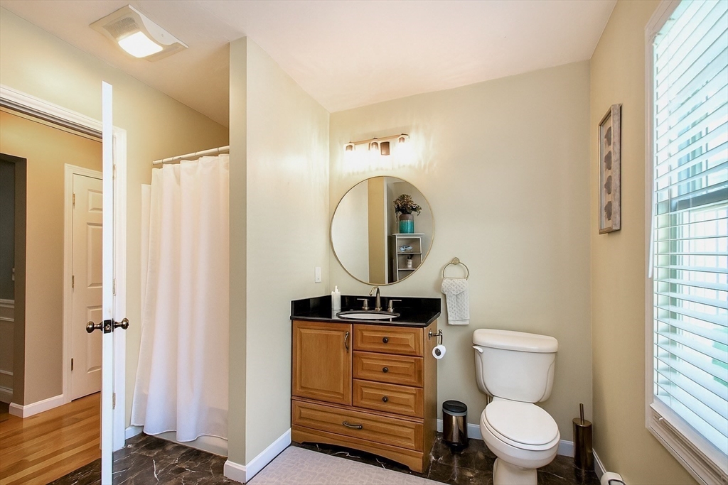 480 Ferry Street Marshfield, MA 02050 - Photo 9 of 34 a bathroom with a toilet a sink and a window