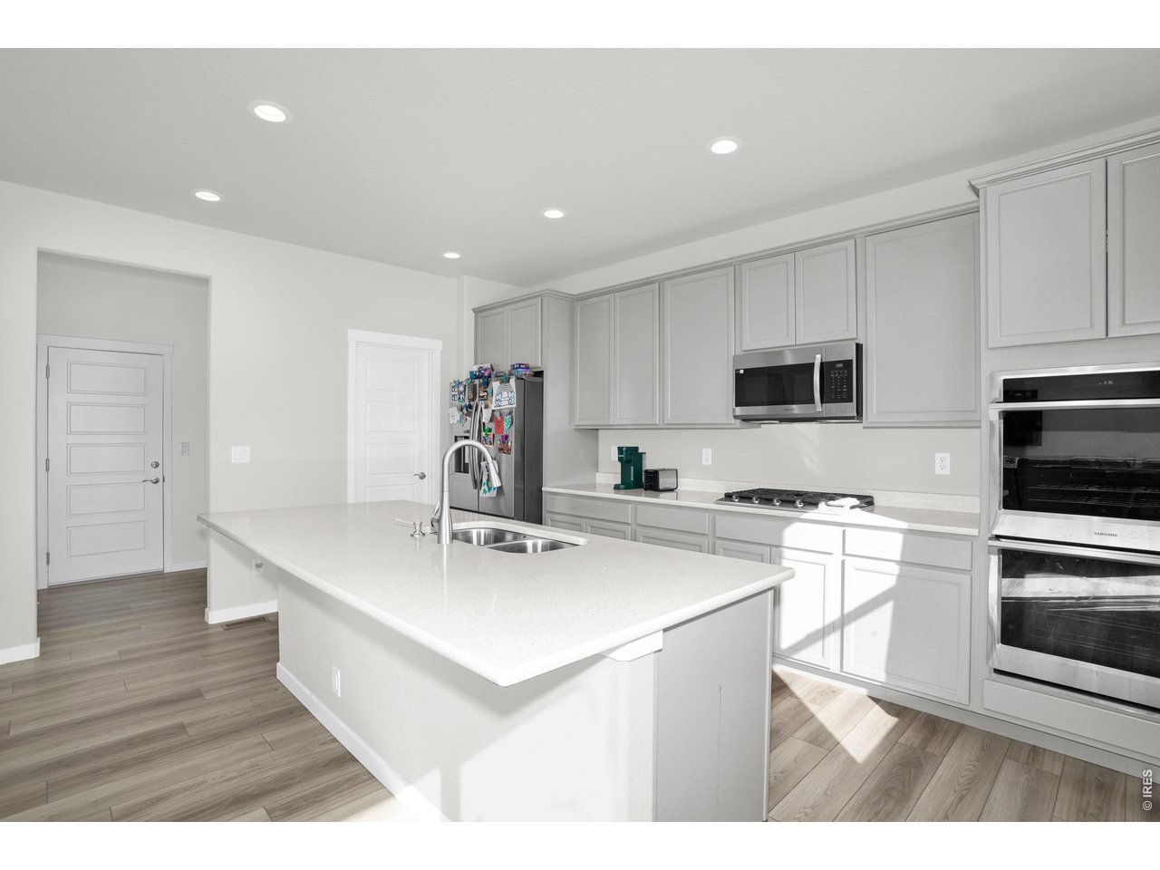 864 Frst Cyn Road Severance, CO 80550 - Photo 11 of 39 a kitchen with stainless steel appliances a sink a stove a refrigerator cabinets and a center island