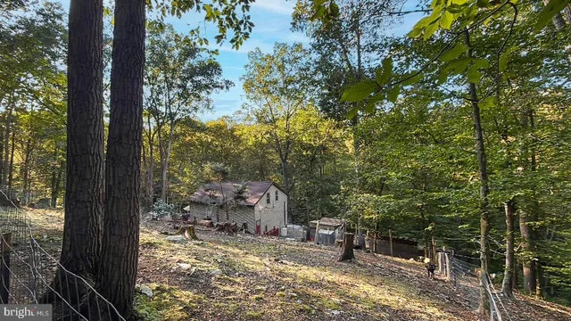 a view of house with outdoor space and sitting area