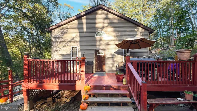 a view of a roof deck with wooden fence and a floor