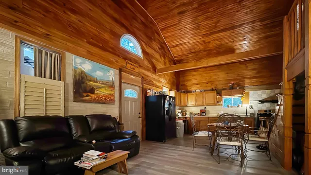 a view of a room with lots of wooden furniture