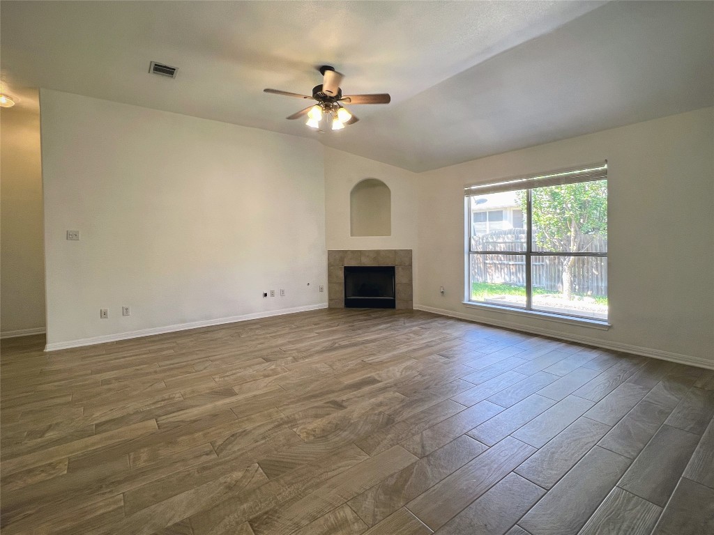 3724 Cheyenne Street Round Rock, TX 78665 - Photo 1 of 4 an empty room with chandelier fan and windows