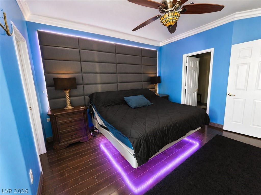 2050 West Warm Springs Road, Unit 2422 Henderson, NV 89014 - Photo 20 of 44 This spacious bedroom features hardwood flooring and crown molding, creating a polished aesthetic.