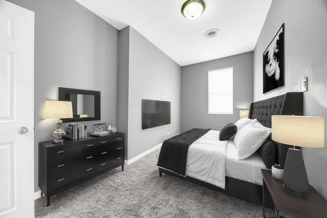 a bedroom with a bed and a window