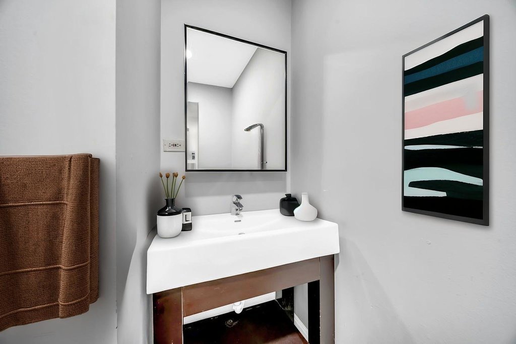 69 East 159th Street Harvey, IL 60426 - Photo 12 of 25 a bathroom with a sink a toilet and a mirror