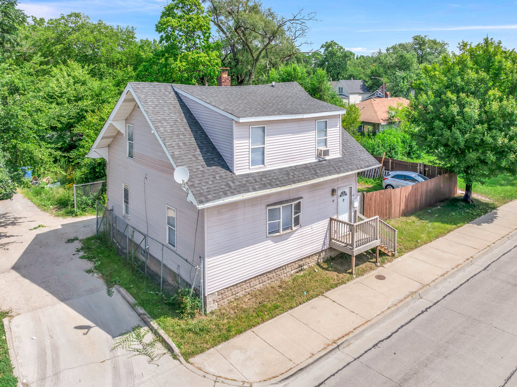 69 East 159th Street Harvey, IL 60426 - Photo 22 of 25 an aerial view of a house with garden space and a bench