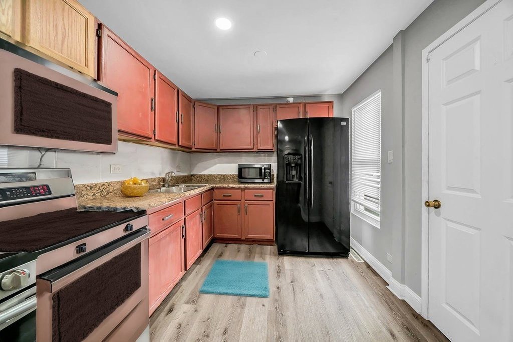69 East 159th Street Harvey, IL 60426 - Photo 4 of 25 a kitchen with stainless steel appliances granite countertop a refrigerator stove and sink