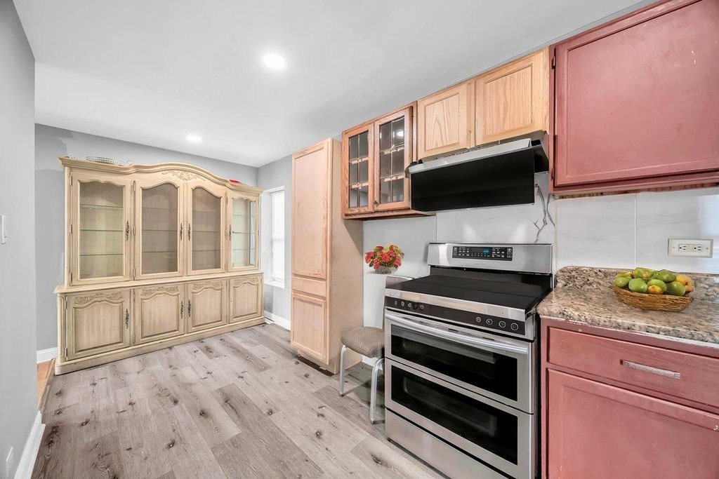 69 East 159th Street Harvey, IL 60426 - Photo 5 of 25 a kitchen with a stove and a microwave
