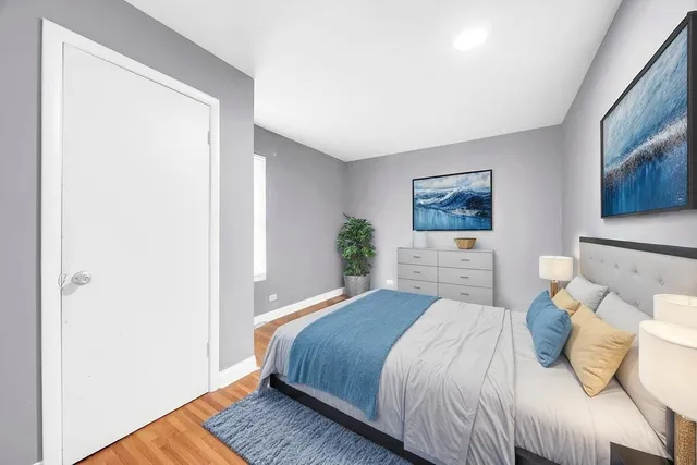 a bedroom with a bed and a painting on the wall