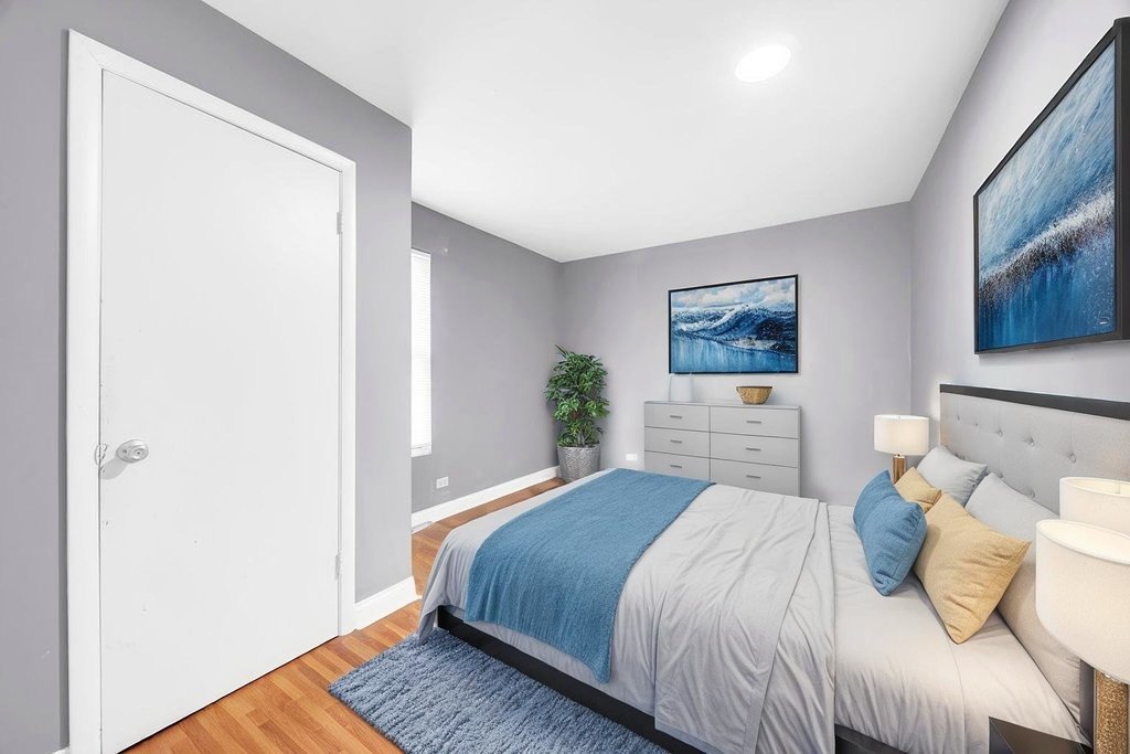 69 East 159th Street Harvey, IL 60426 - Photo 9 of 25 a bedroom with a bed and a painting on the wall